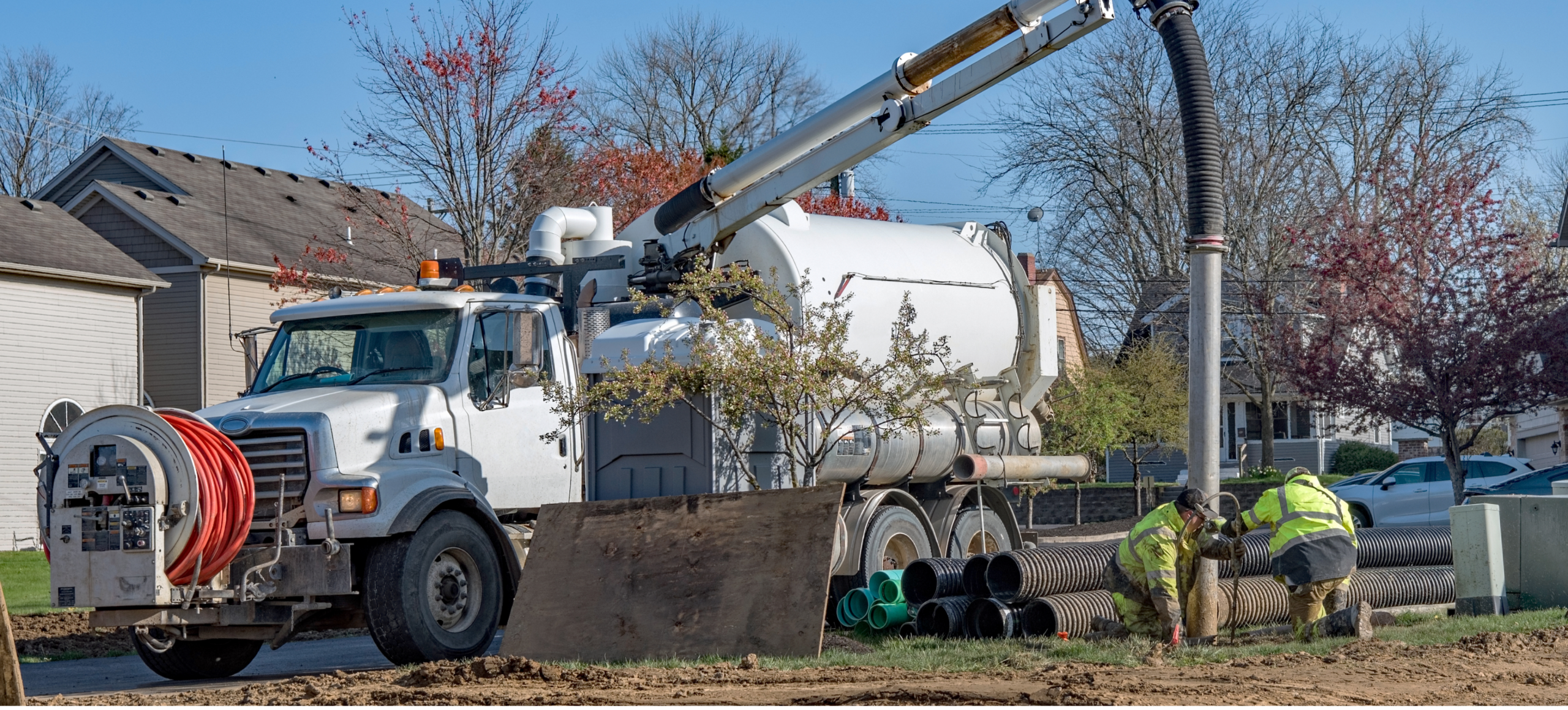 Vacuum truck at worksite with workers